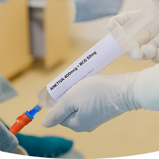 Healthcare professional administering ANKTIVA immunotherapy via syringe in a clinical treatment setting